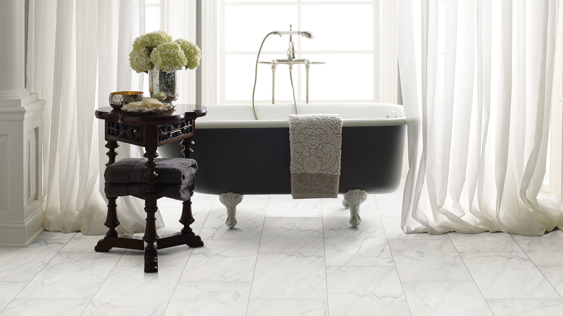 marble tile flooring in a bright white bathroom with a tub